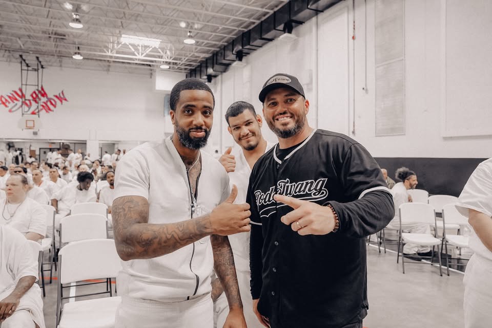 Two men giving thumbs up at Worthy People prison event