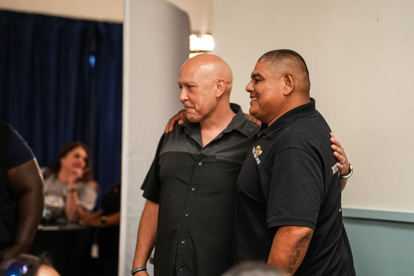Two men embracing at Worthy People event