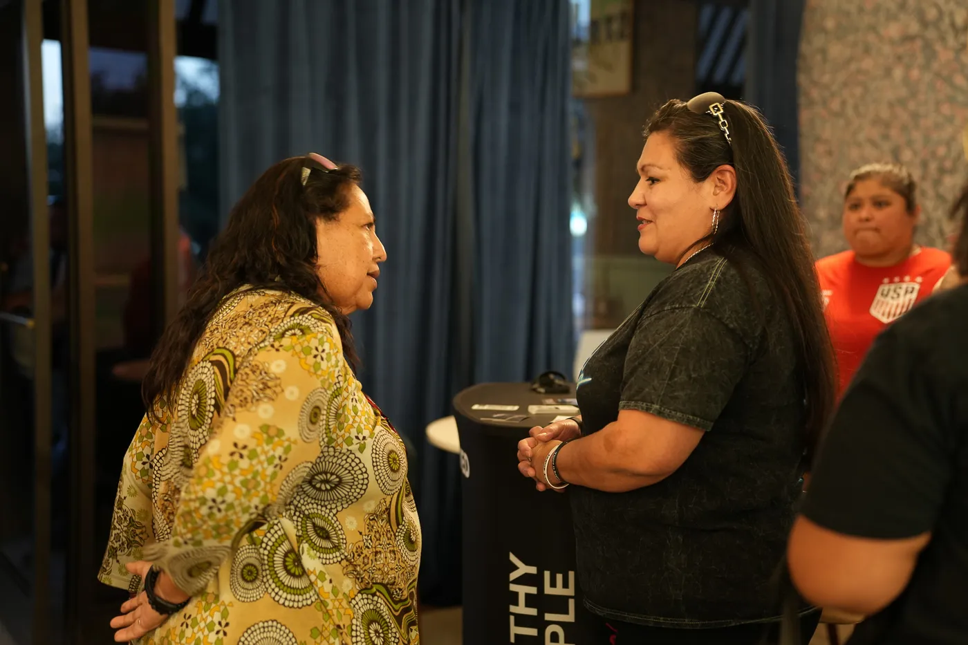 Two women in conversation at Worthy People event