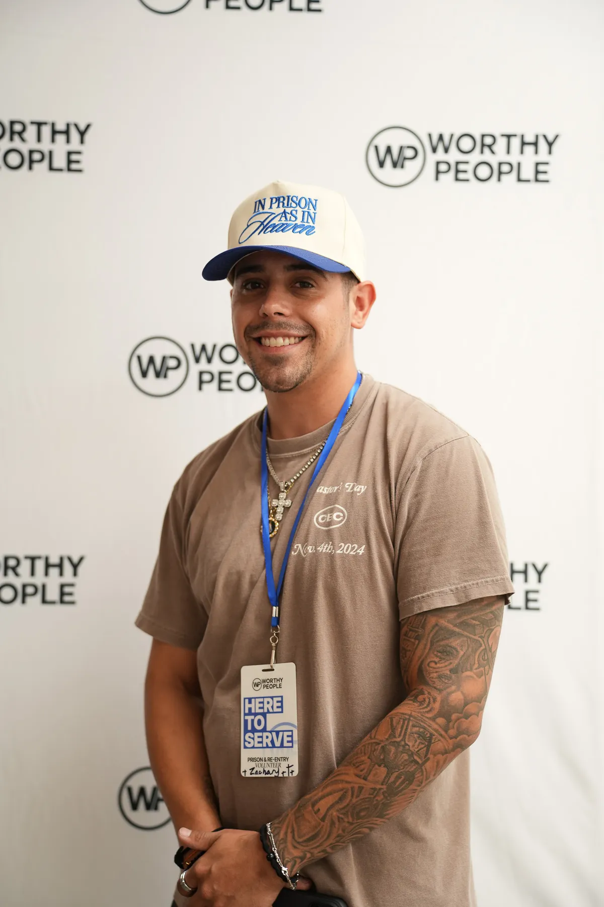 Guest wearing Here to Serve lanyard at Worthy People event