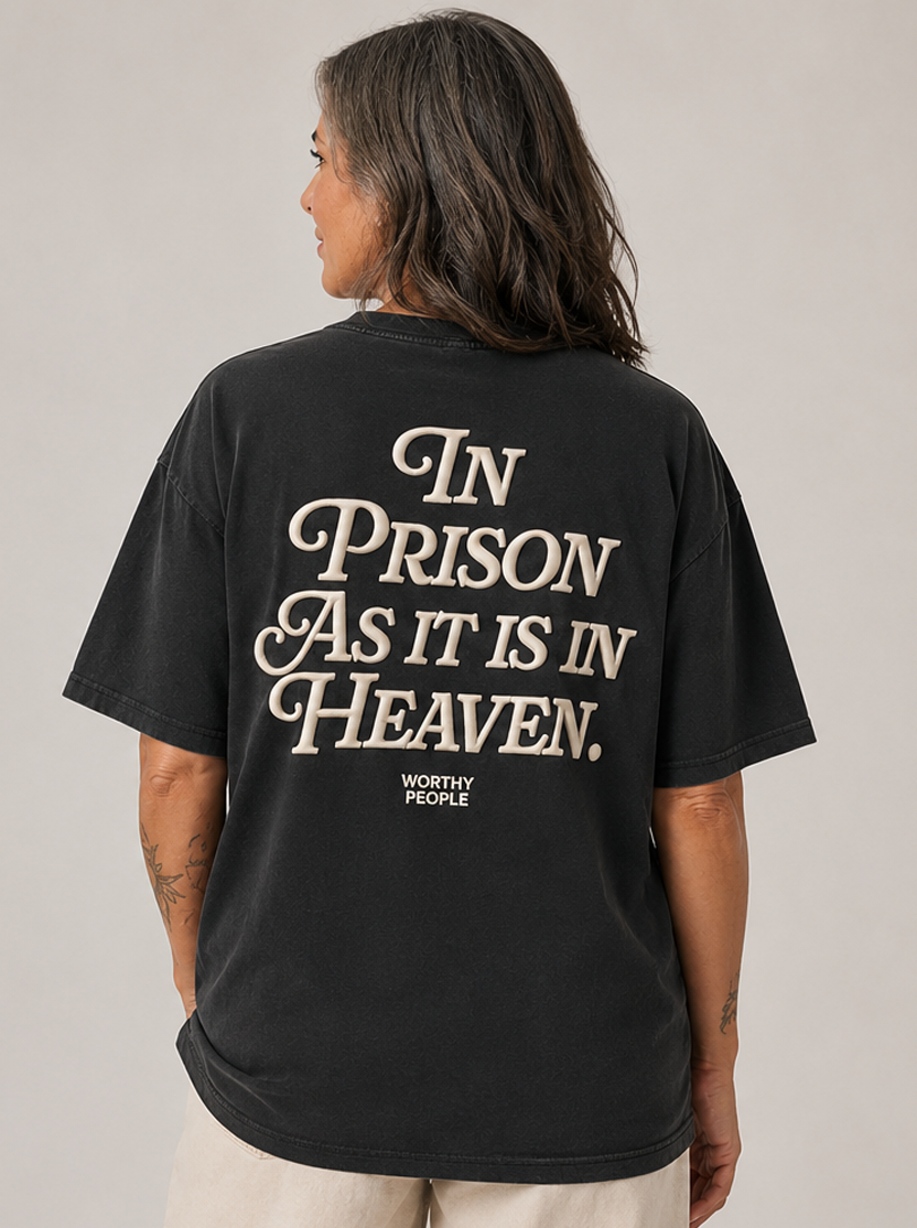 Black tee with a striking back print proclaiming heaven's hope inside prison walls.