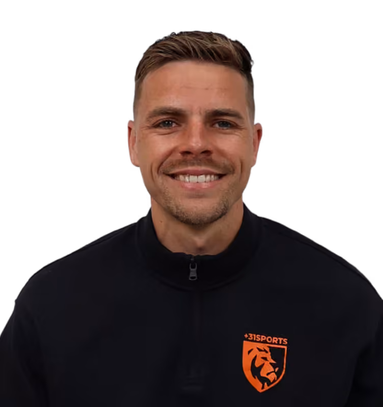 Smiling man with short hair wearing a black jacket with orange +31SPORTS lion logo.