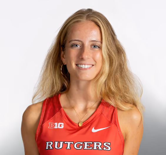 Smiling female athlete in a red Rutgers sports jersey with blonde hair against a white background.