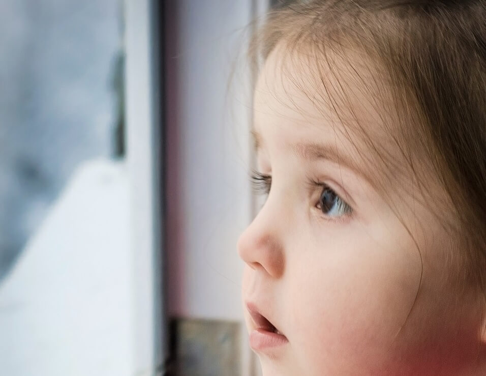 Child looking out window to the future