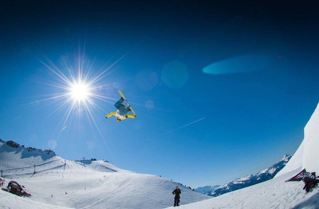 Snowboarder performing a nose grab while catching big air.