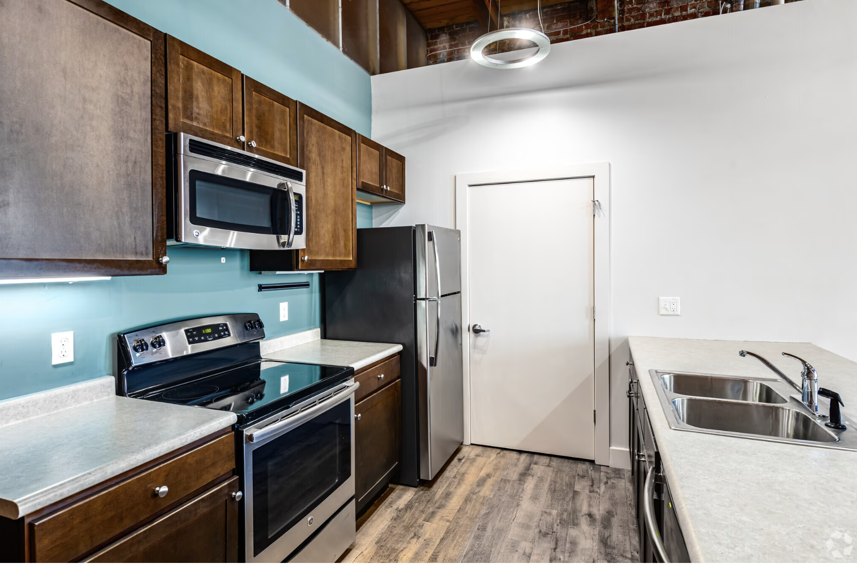 Kitchen with brown cabinets and stainless steel appliances