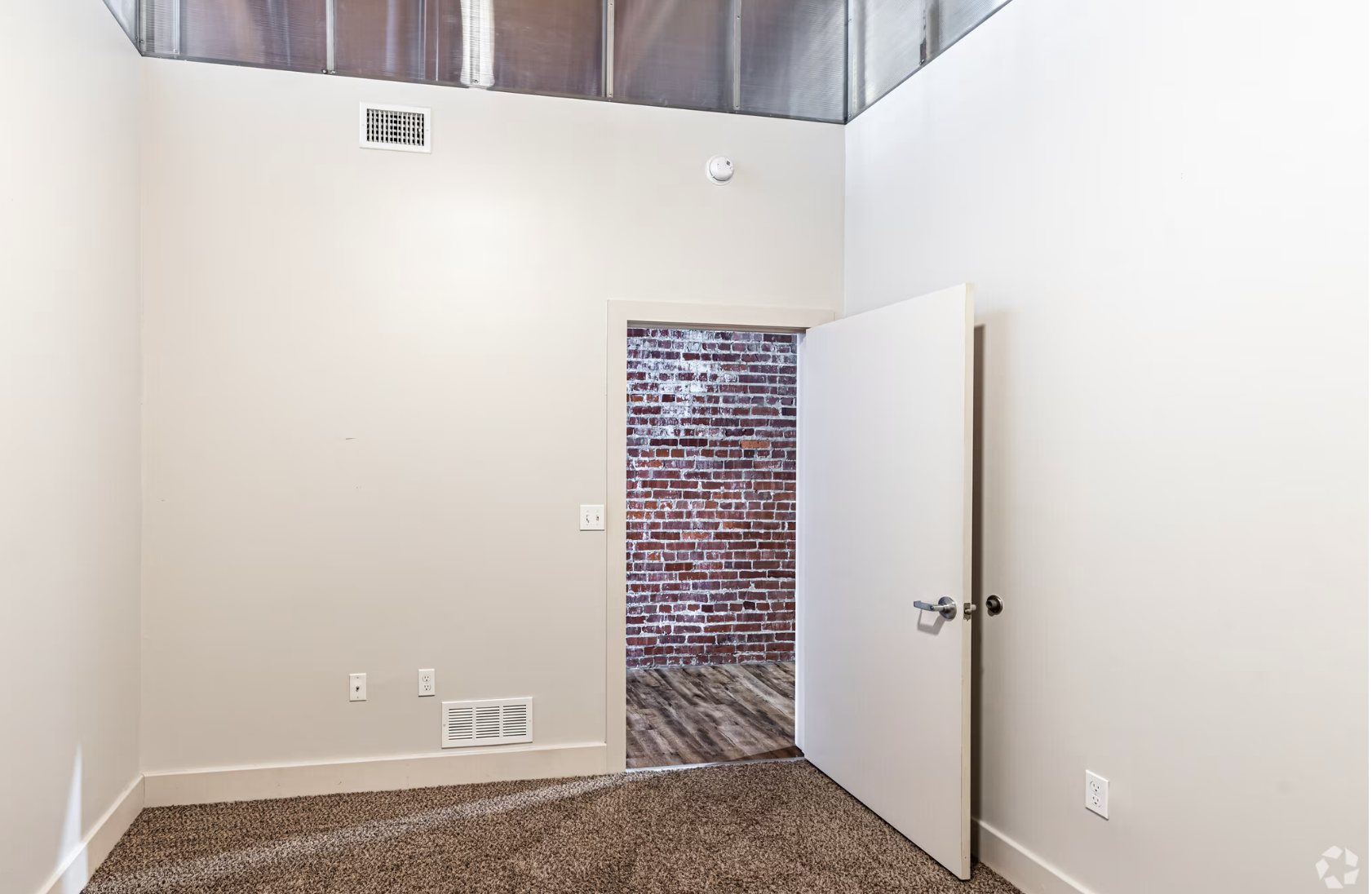 Bedroom with white walls and carpet