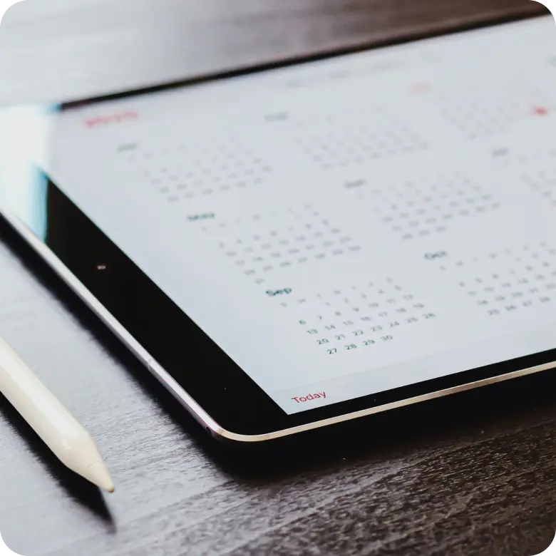 Tablet displaying a calendar on a desk.