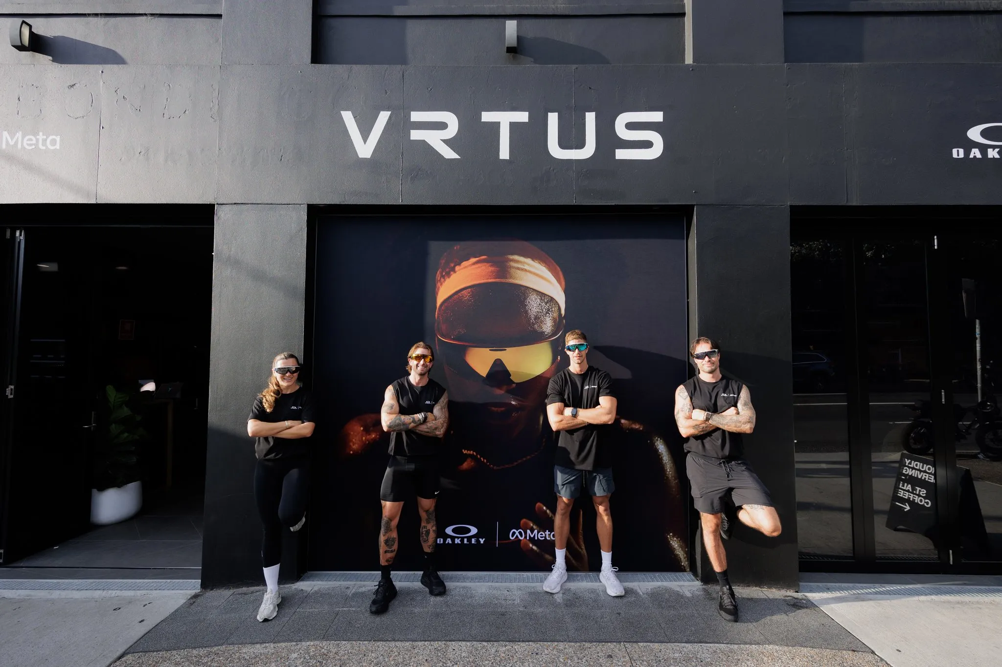 Guests stand outside the VRTUS venue beneath Oakley Vanguard branding.