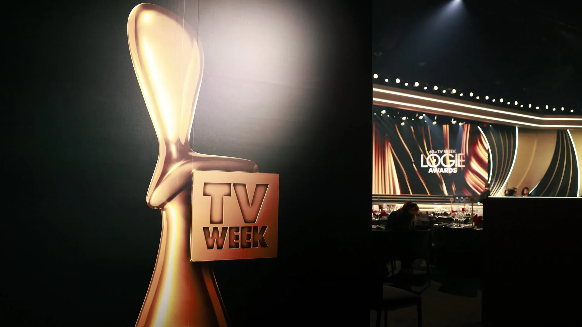 TV Week Logies trophy graphic beside the gold-and-black awards stage.