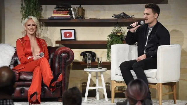 Two speakers hold a seated conversation on the Creator Summit stage.