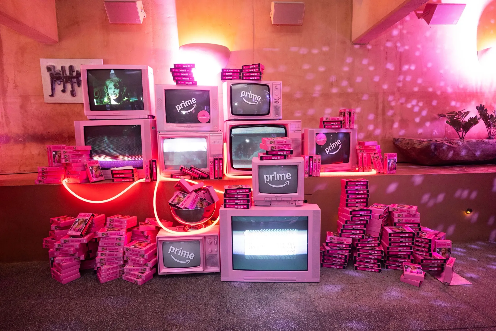 Stacked vintage televisions and pink displays at the Prime Video Elle launch.