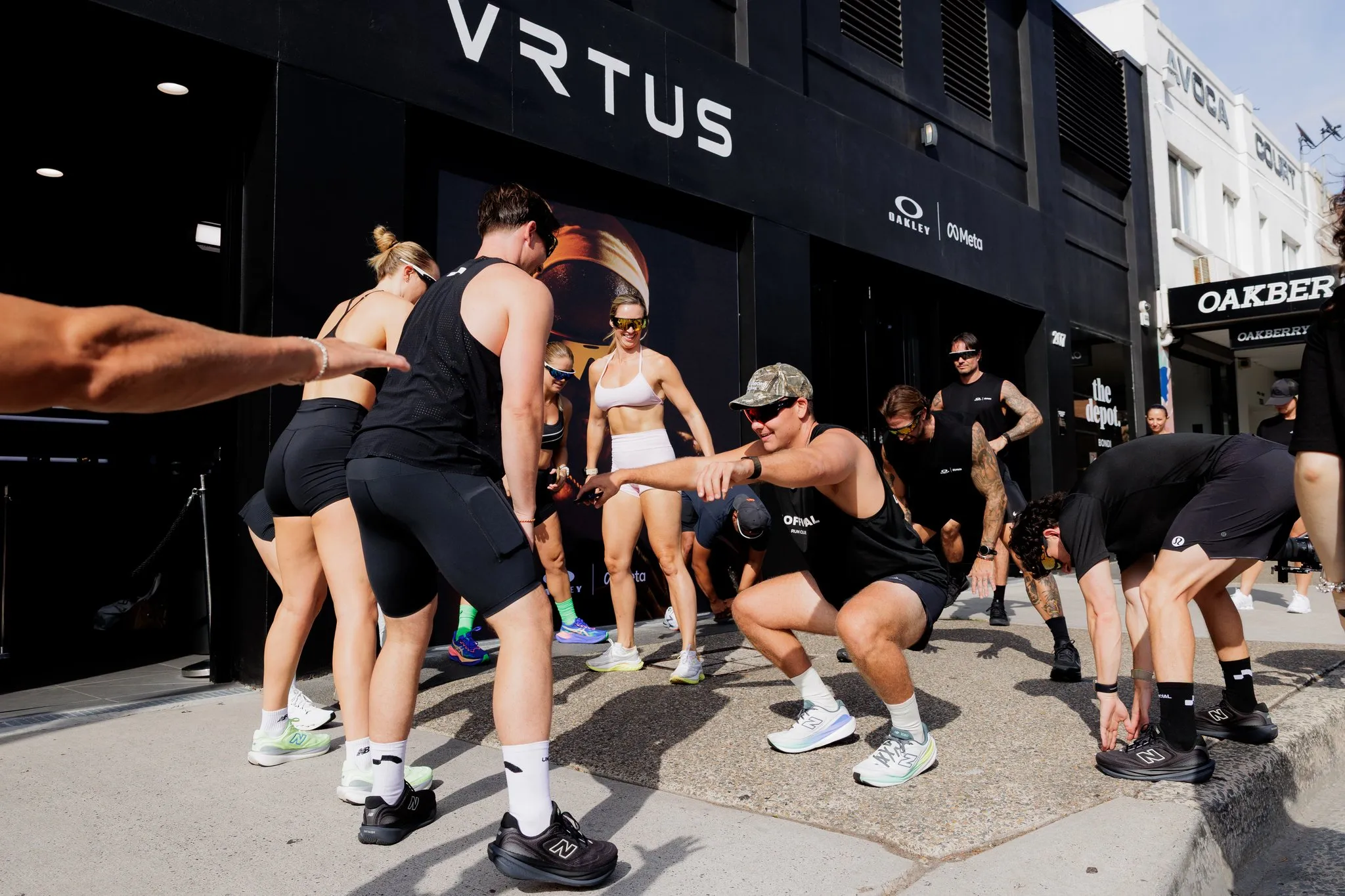 Participants stretch together outside the VRTUS venue during the Oakley Vanguard event.