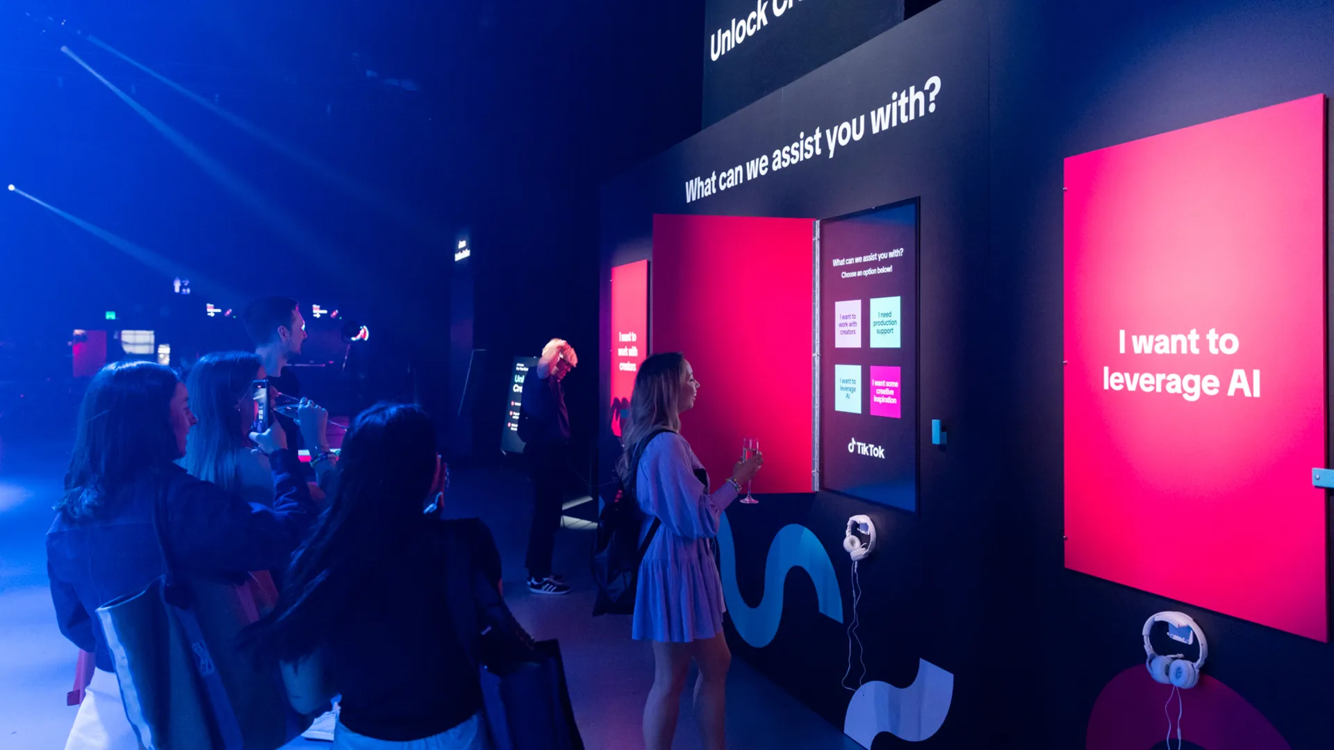 Visitors explore illuminated interactive display panels at the TikTok summit.