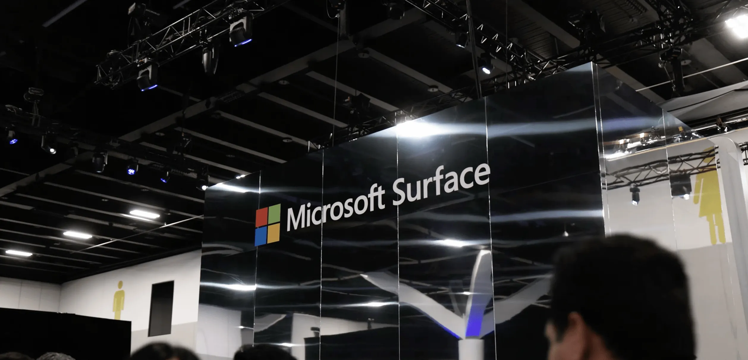 Microsoft Surface branding displayed on a tall black panel inside the event venue.