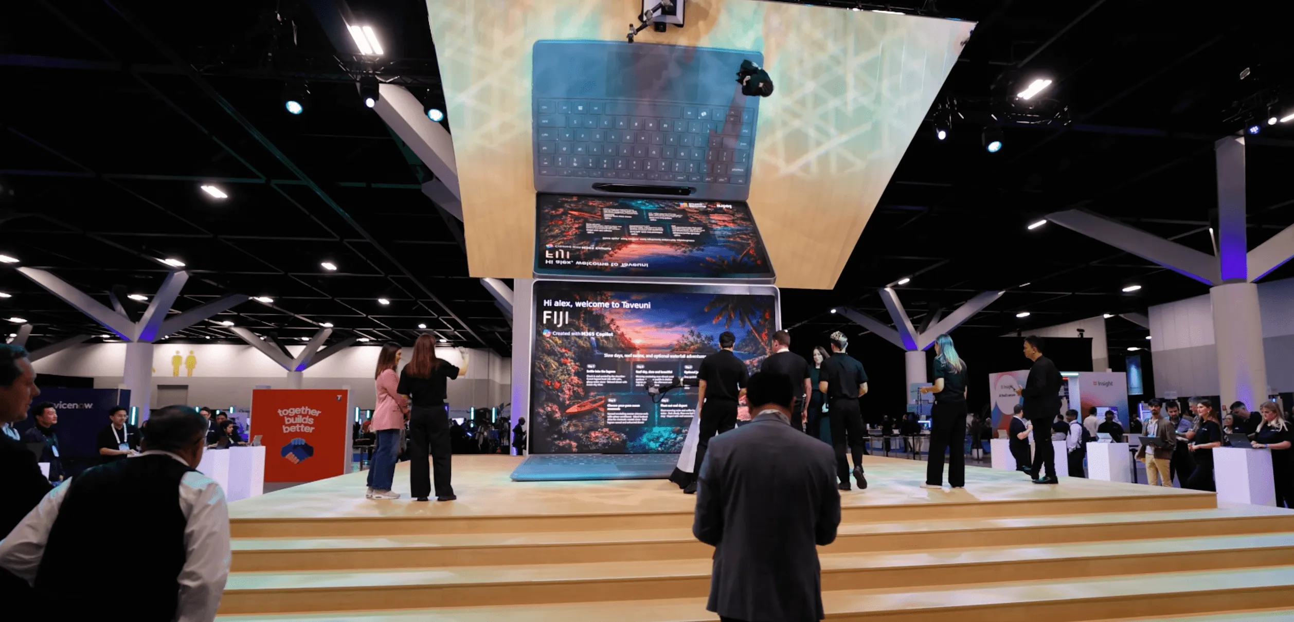 Guests approach the large Microsoft Surface installation inside an exhibition hall.