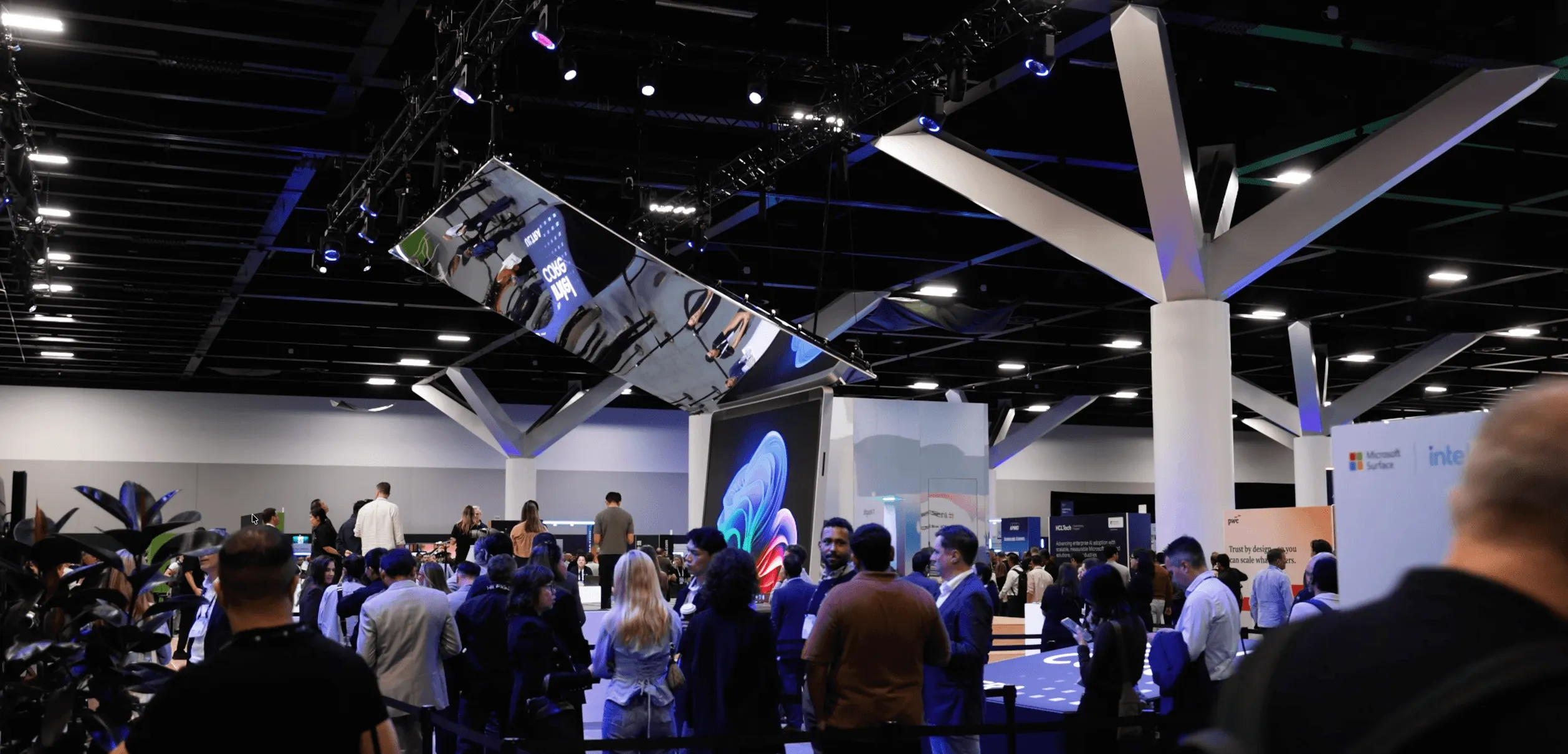 Crowd gathers around the oversized Microsoft Surface display.
