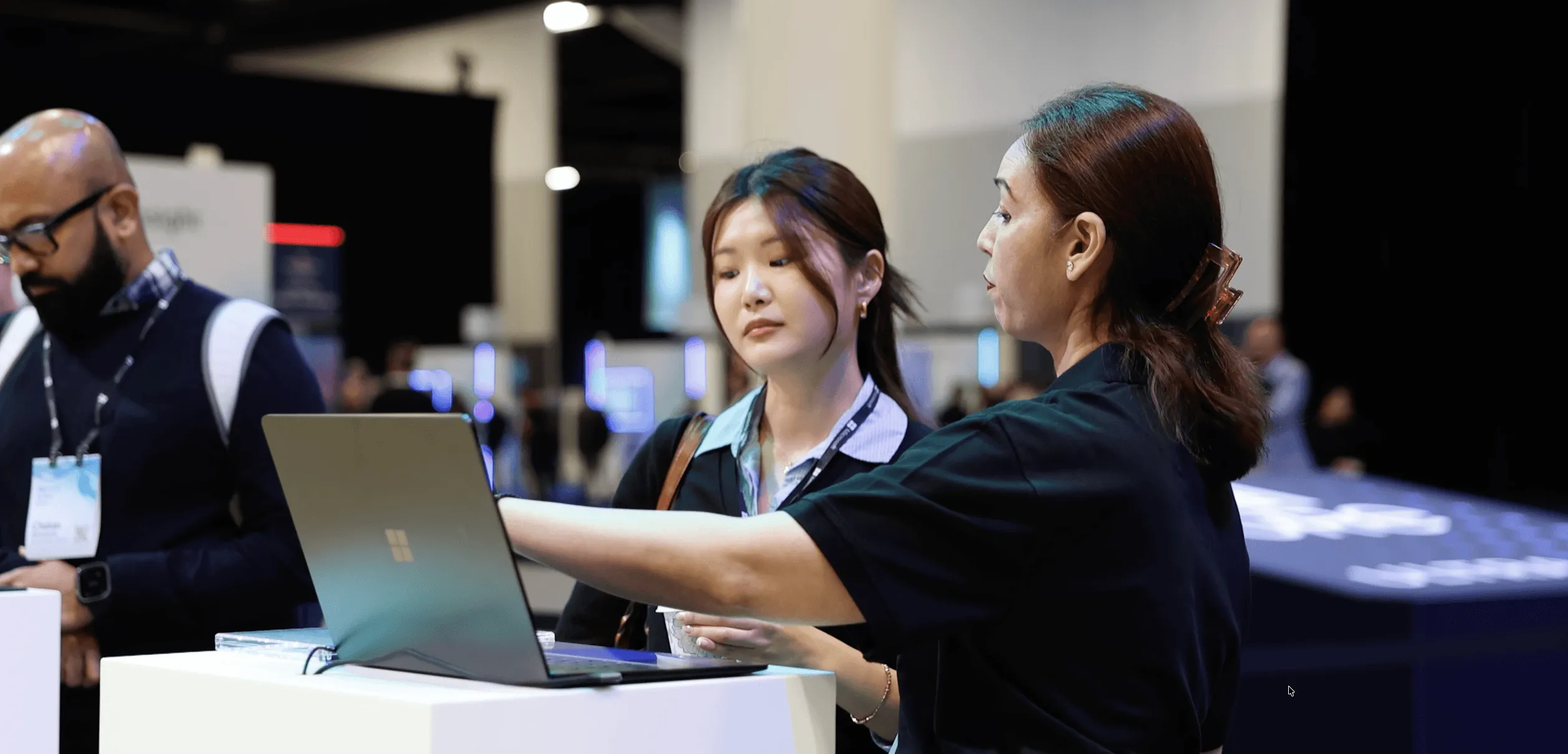 Attendees receive a demonstration of a Microsoft Surface device.