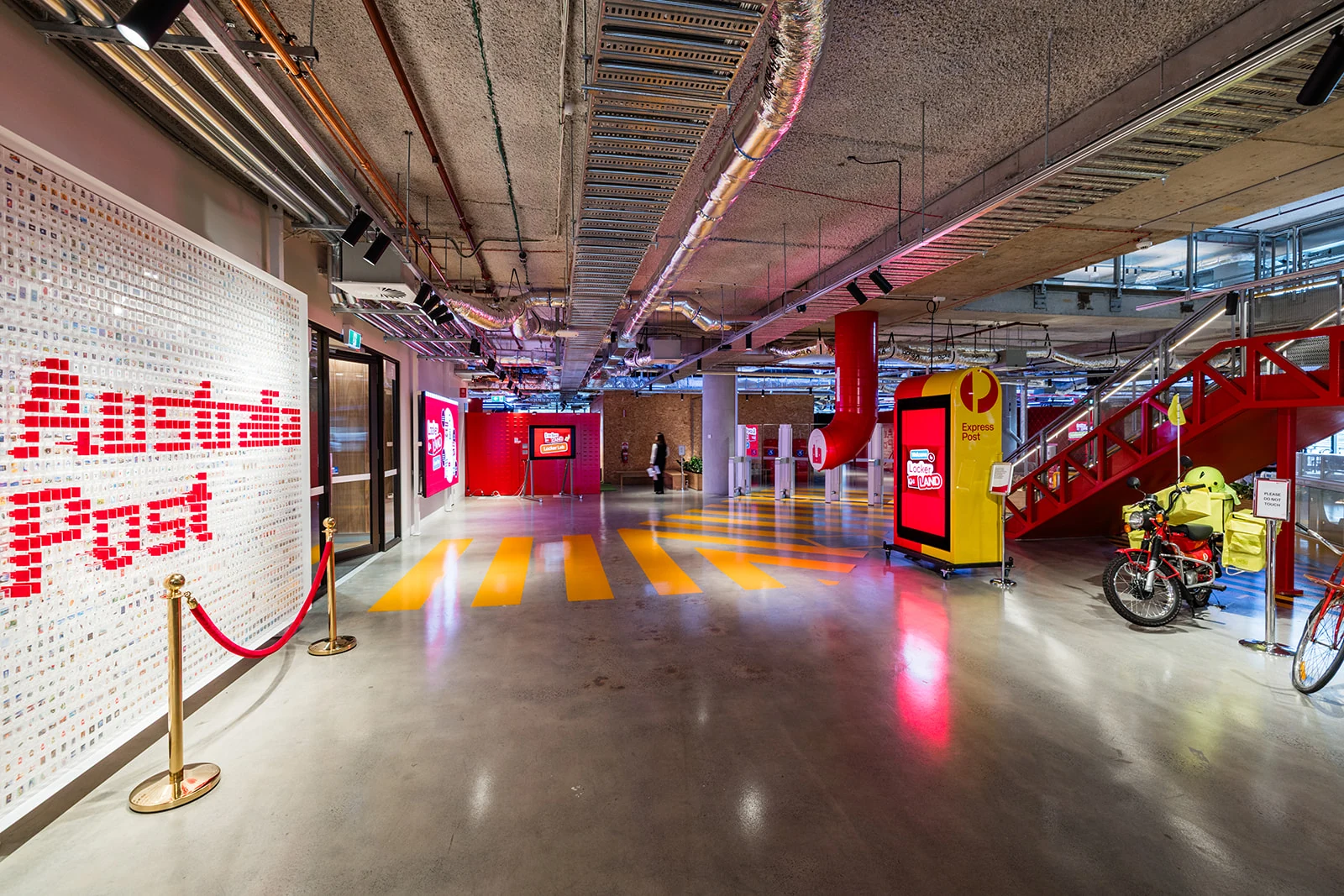 Australia Post branding and a red carpet lead into the Locker Land event space.