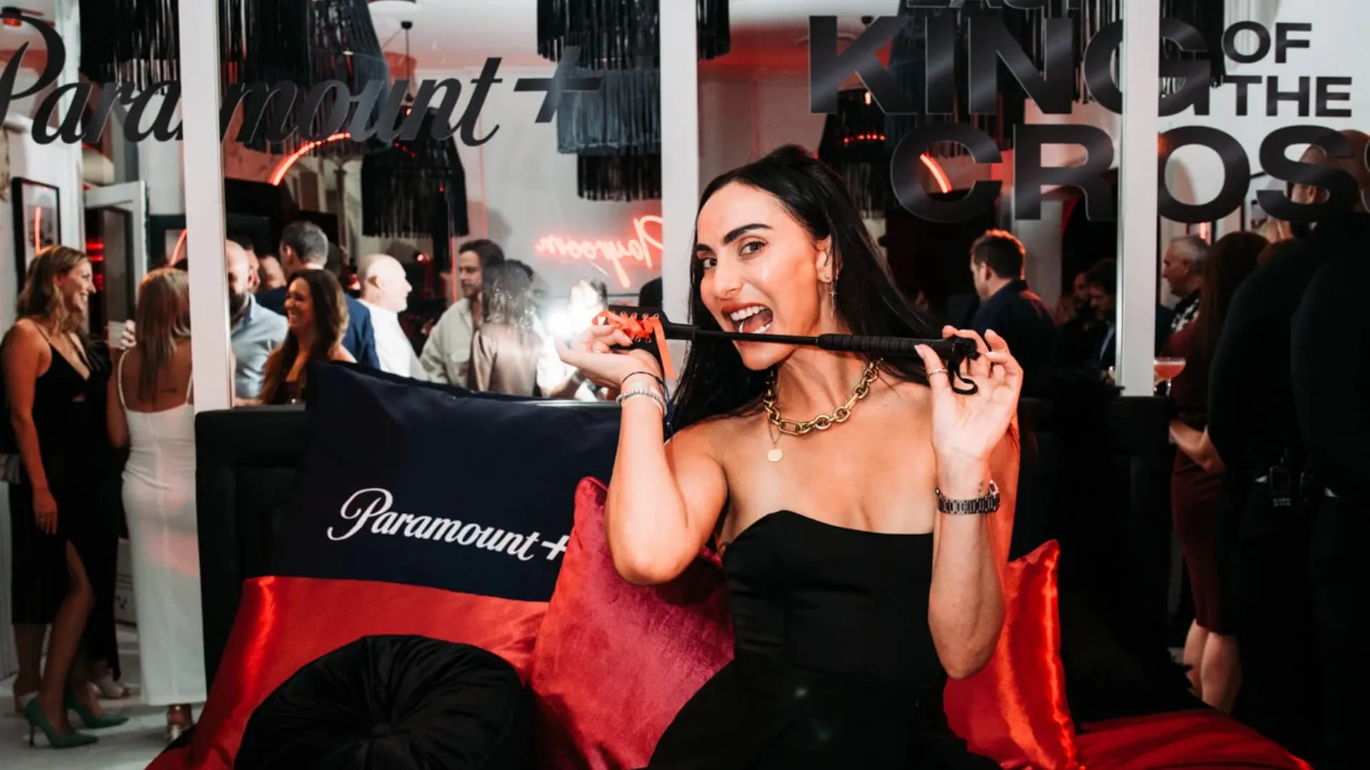 Guest holds a Paramount+ branded cushion at the Last King of the Cross launch.