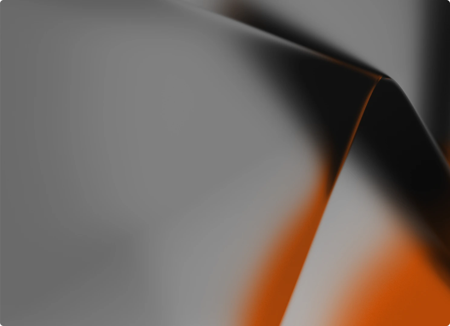 Abstract blurred shapes in black, gray, and orange with soft gradients.