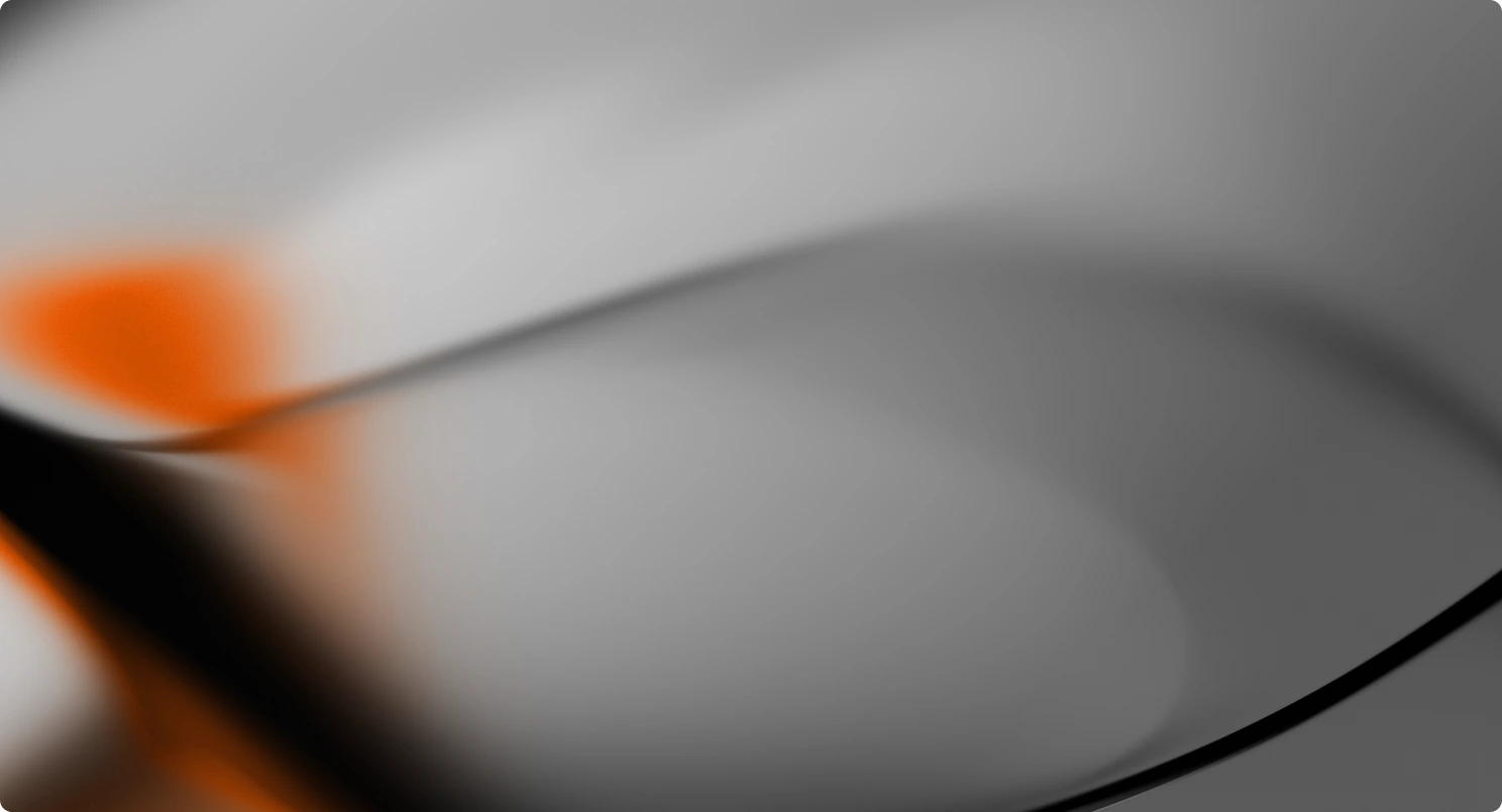 Abstract blurred background with flowing black and orange shapes on a soft gray gradient.