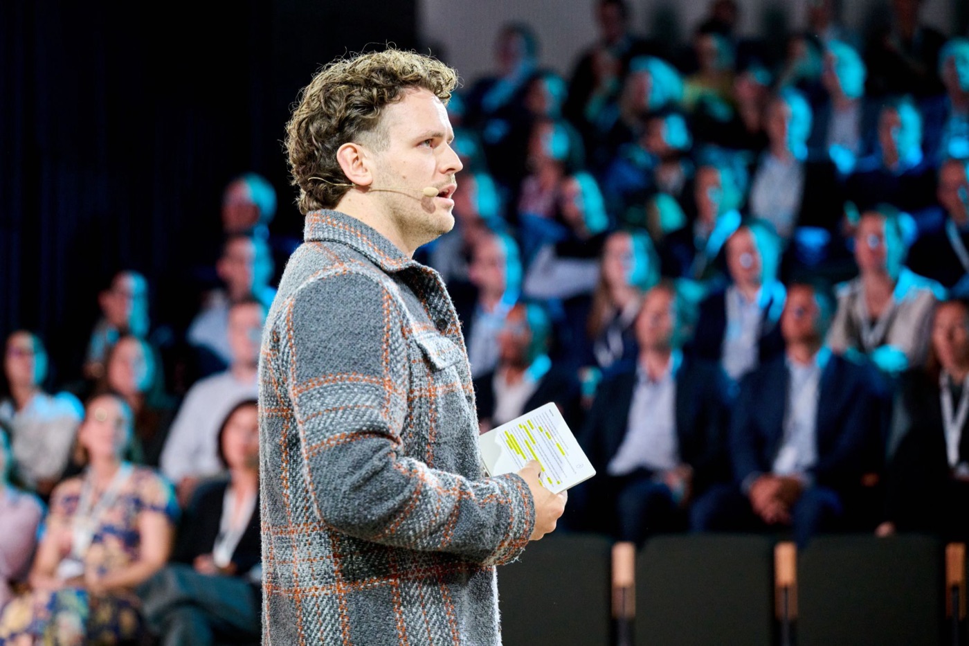 dr. Mathias Celis on stage in front of a full audience
