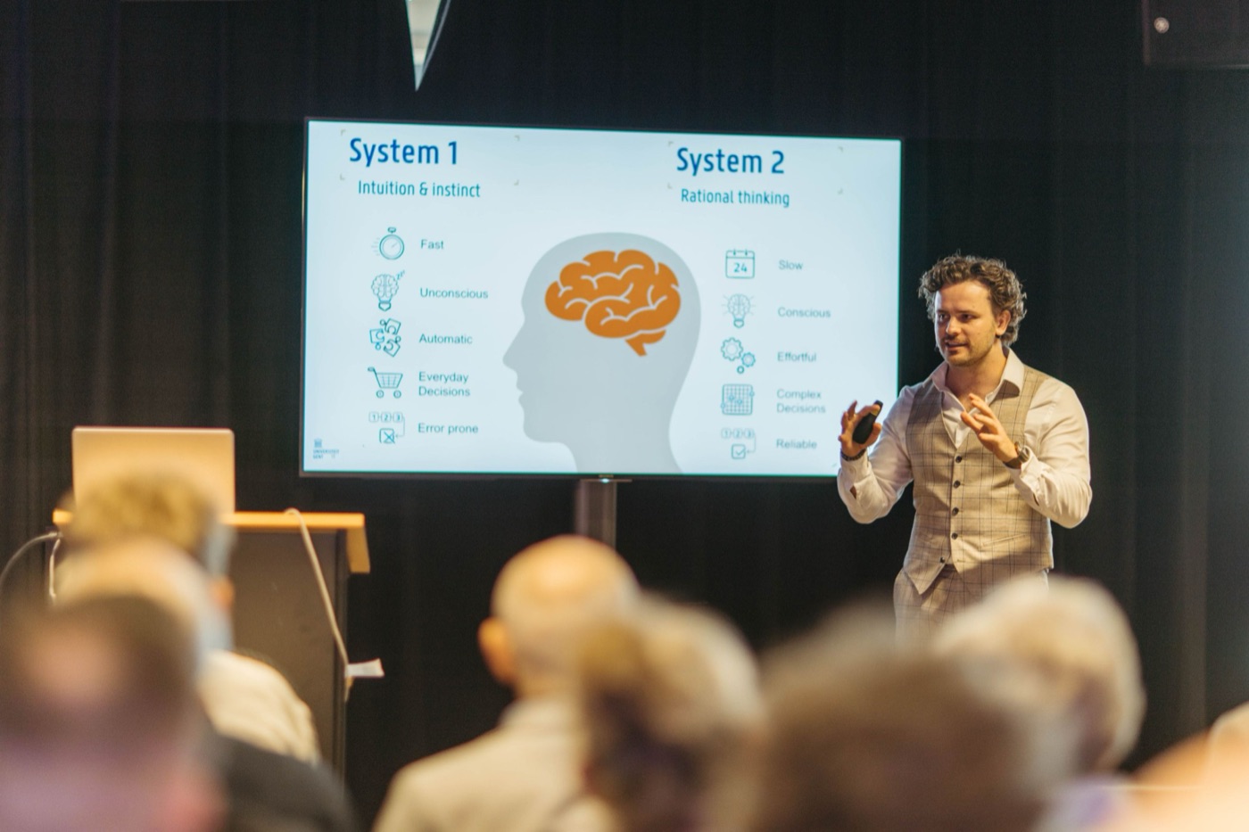 dr. Mathias Celis presenting a slide on System 1 and System 2 thinking