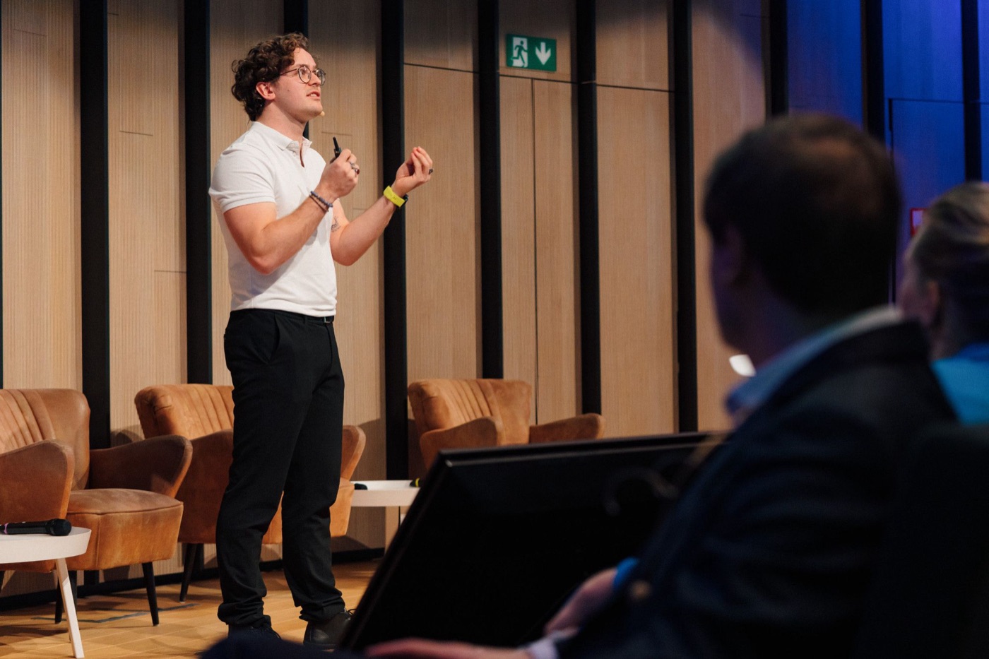 dr. Mathias Celis explaining a point on stage