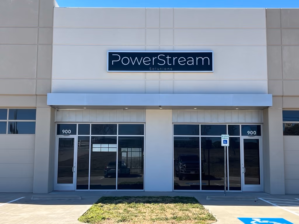 Exterior of PowerStream Solutions office with glass doors numbered 900 and a handicapped parking spot.