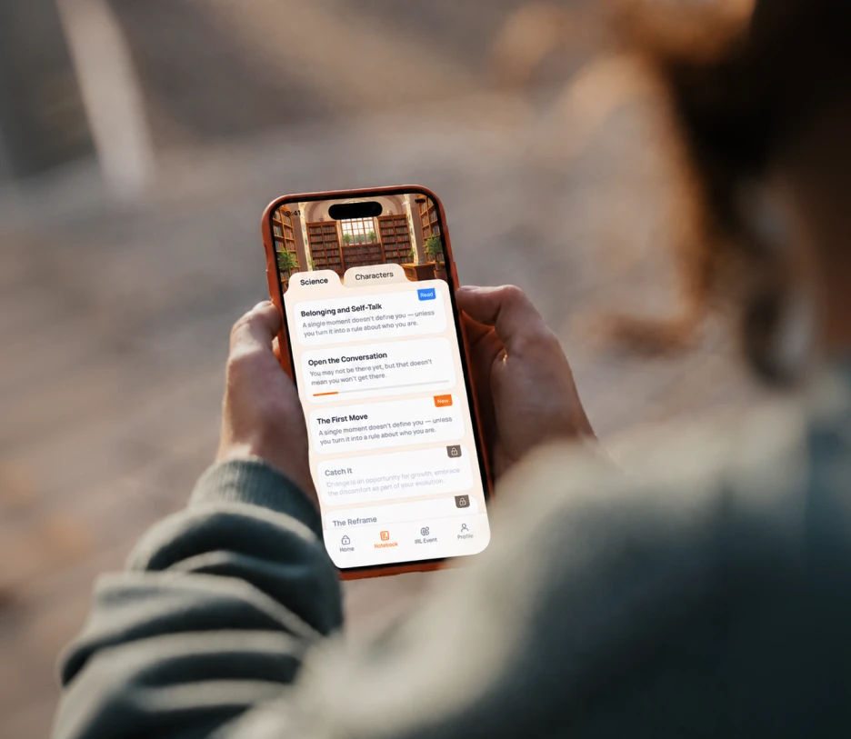 Person holding smartphone showing an app with tabs and a list of guided self-help topics.