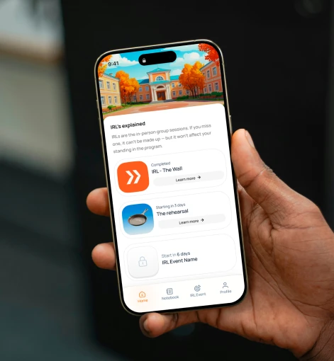 Hand holding smartphone showing an app with IRL group sessions and event schedules.