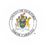 Seal of Guilford County, North Carolina, featuring a shield with symbols and two lions.