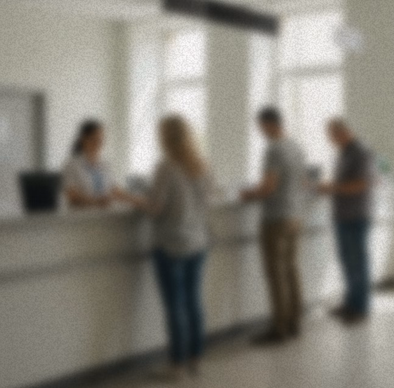 Blurred bg of people standing at reception
