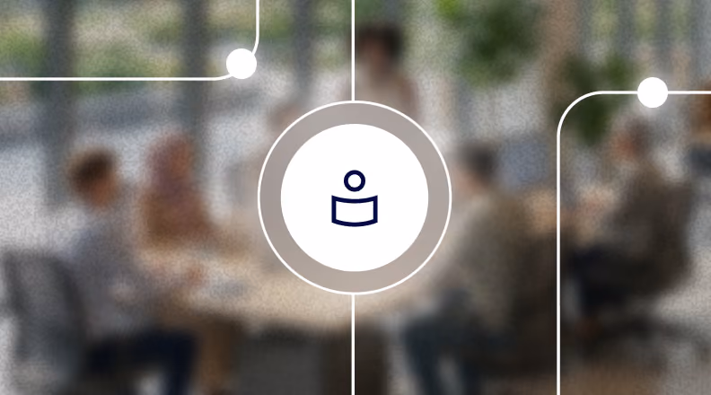 Blurred office meeting with digital icon overlay at center featuring a person with a curved chart below.