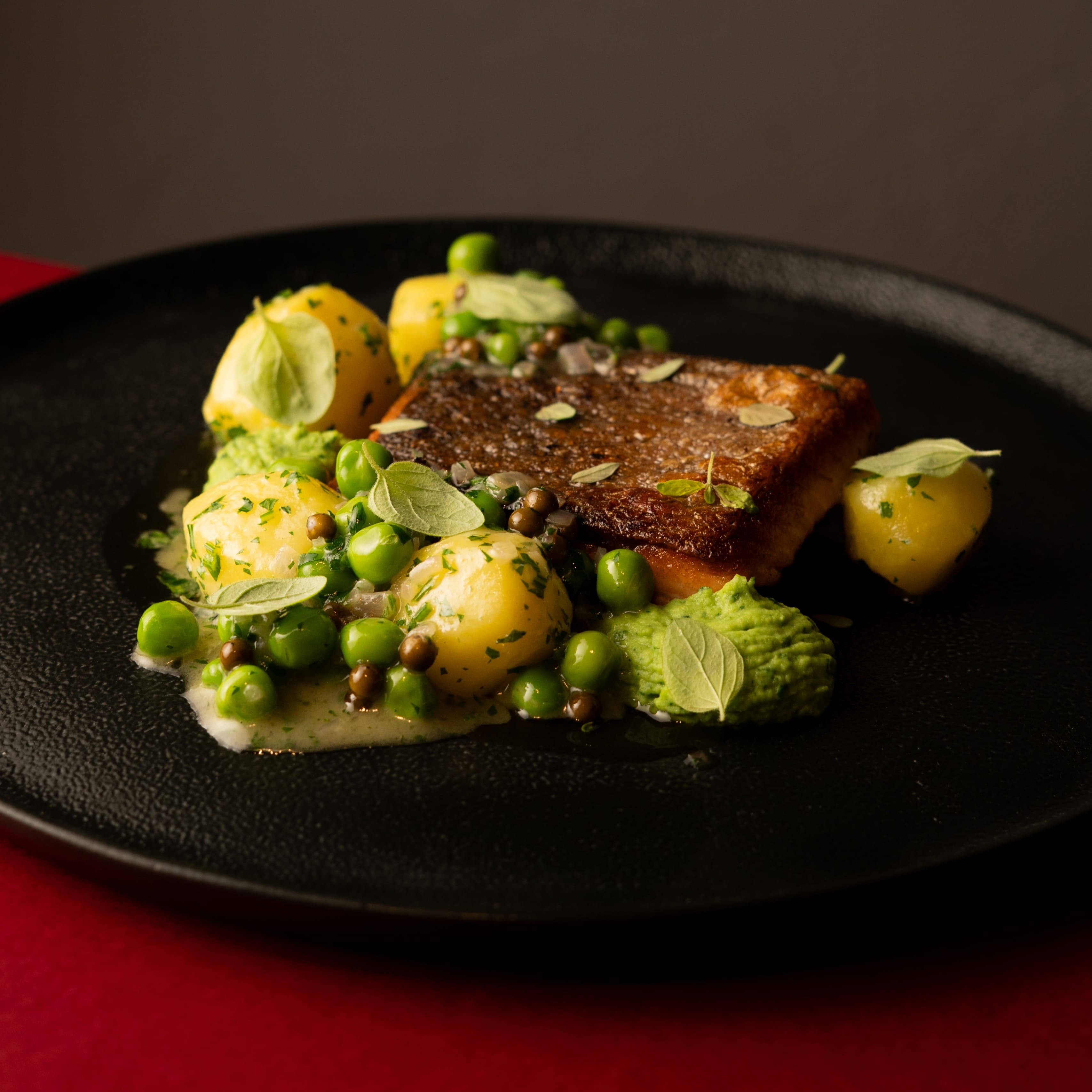 Pan seared salmon with green pea puree and roasted potatoes at ANTARES Lounge