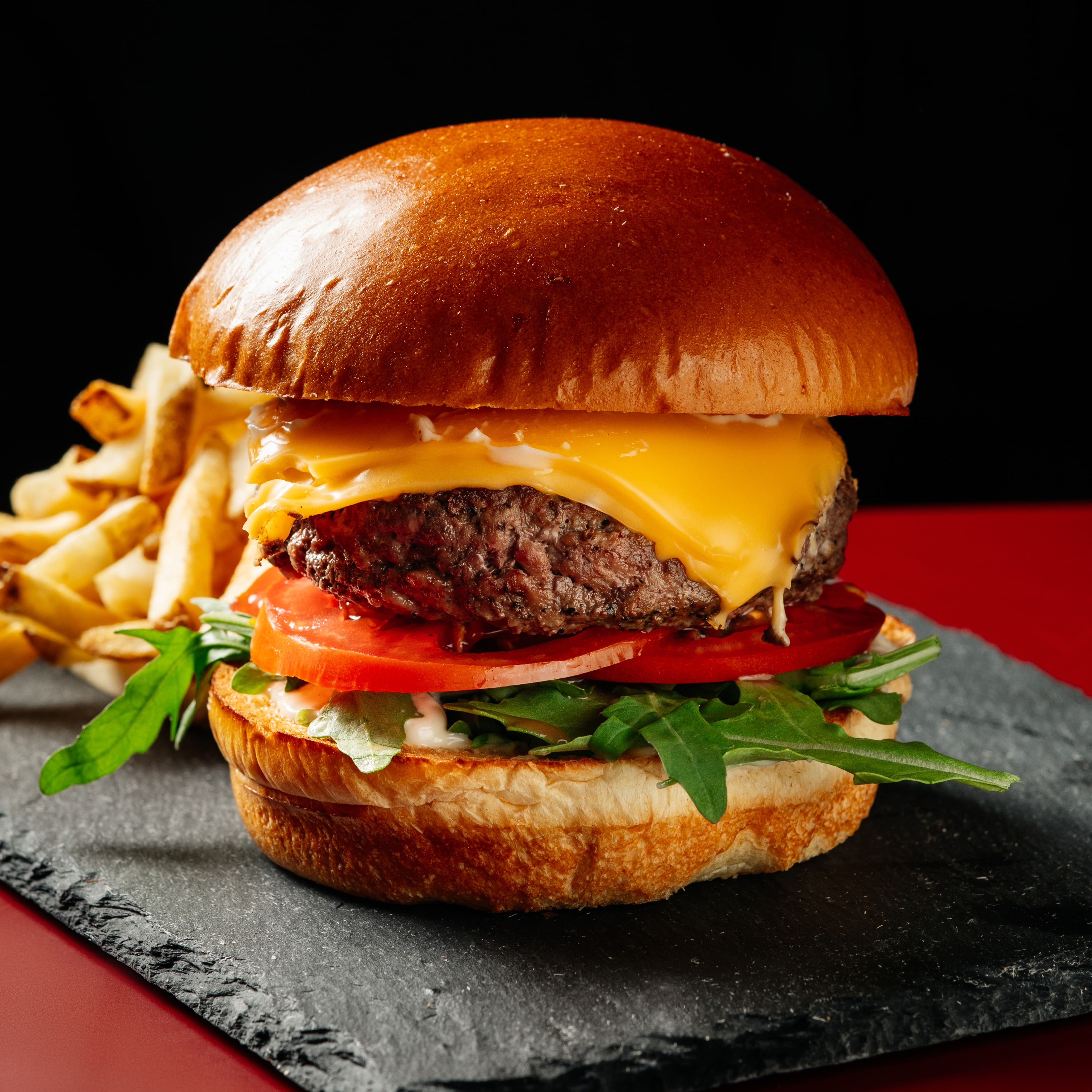 Signature beef burger with cheese, pesto mayonnaise and roasted potatoes at ANTARES Lounge