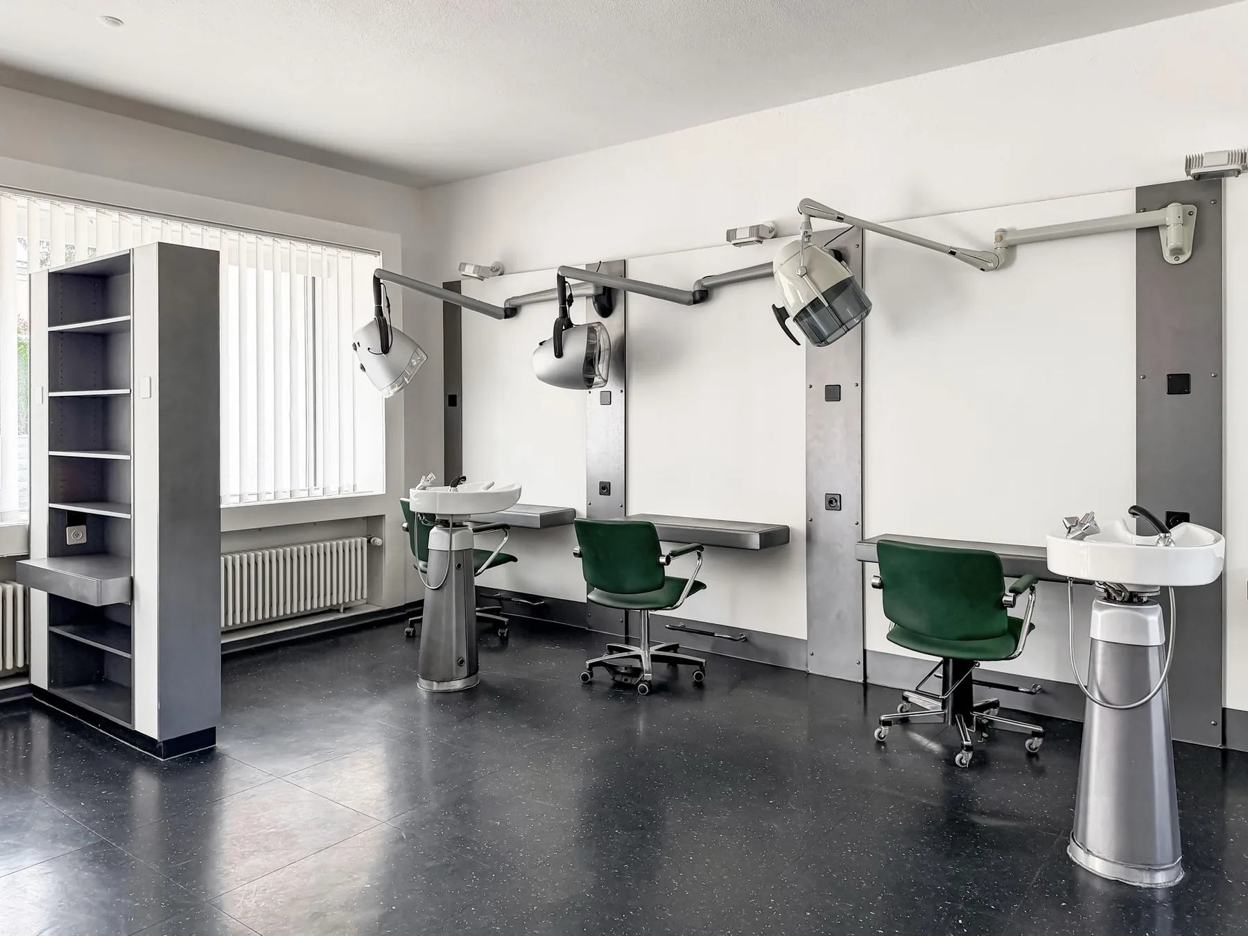 Arbeitsplätze mit grünen Stühlen und Waschbecken im Gewerberaum an der Witikonerstrasse 423