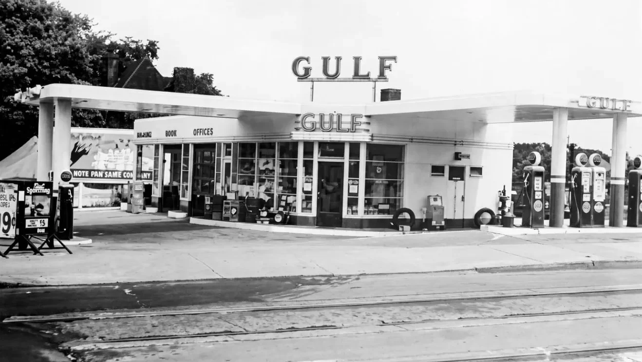 Gulf service station with canopy and gas pumps, 1930s black-and-white photo