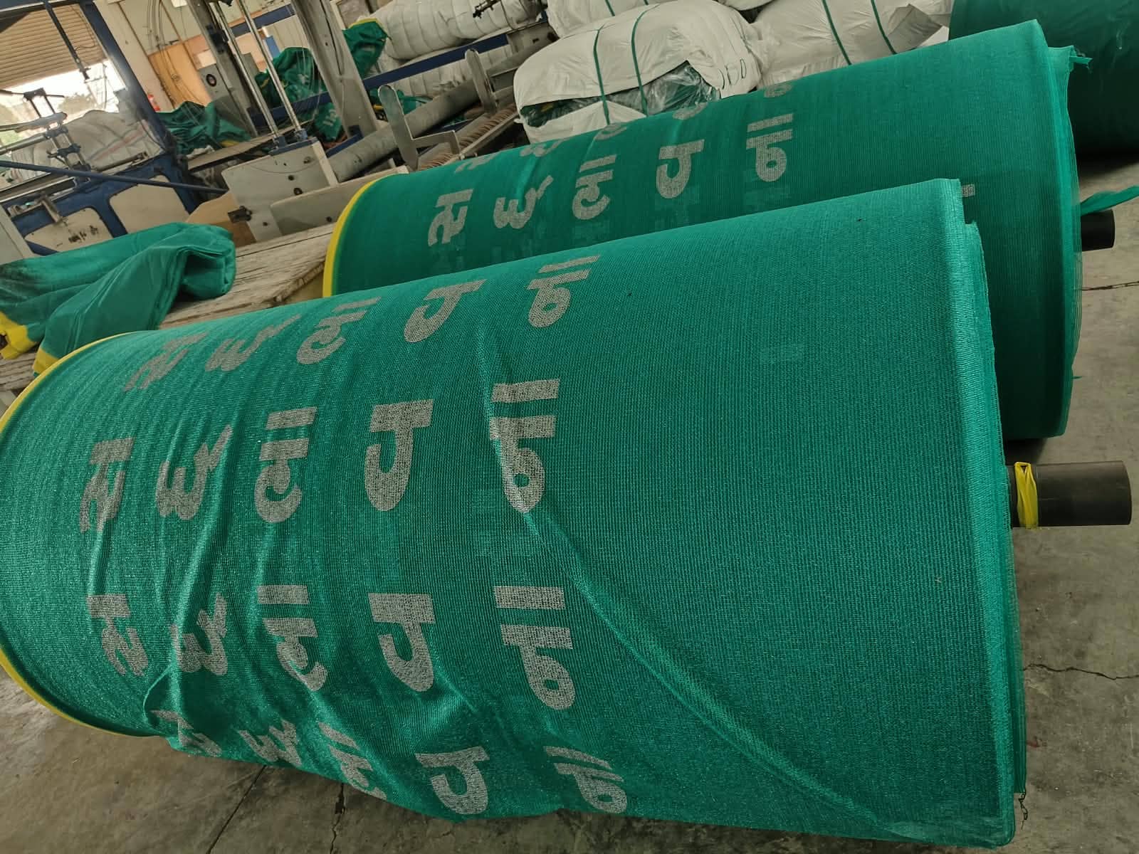 Finished rolls of custom printed green shade net produced by Sunsafe Agrotextiles
