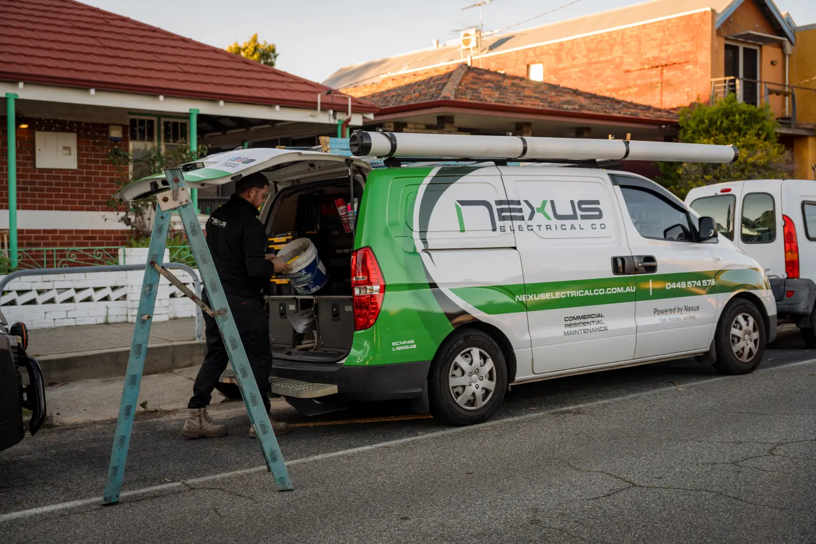 Nexus Electrical Co electrician working beside a service van at a residential property in Gwelup