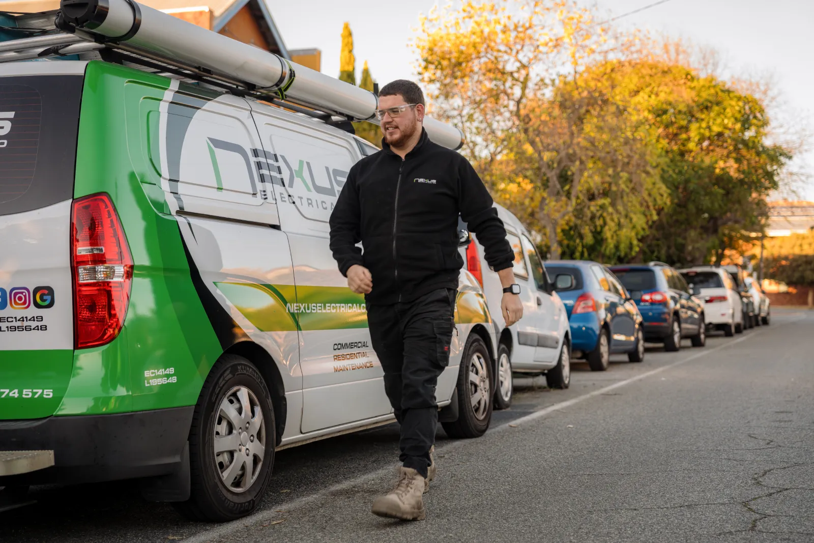 Nexus Electrical Co electrician walking beside a service van in Trigg