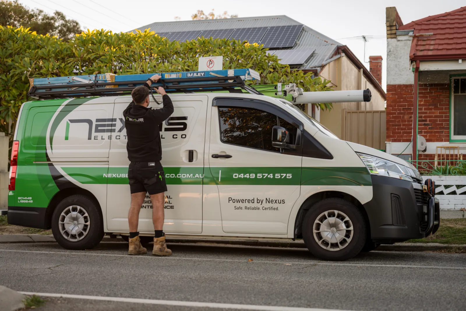 Nexus Electrical Co electrician working beside a service van at a residential property in Hillarys
