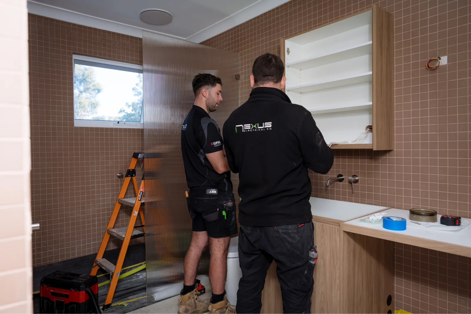 Nexus Electrical Co electricians working on an electrical installation in a residential bathroom