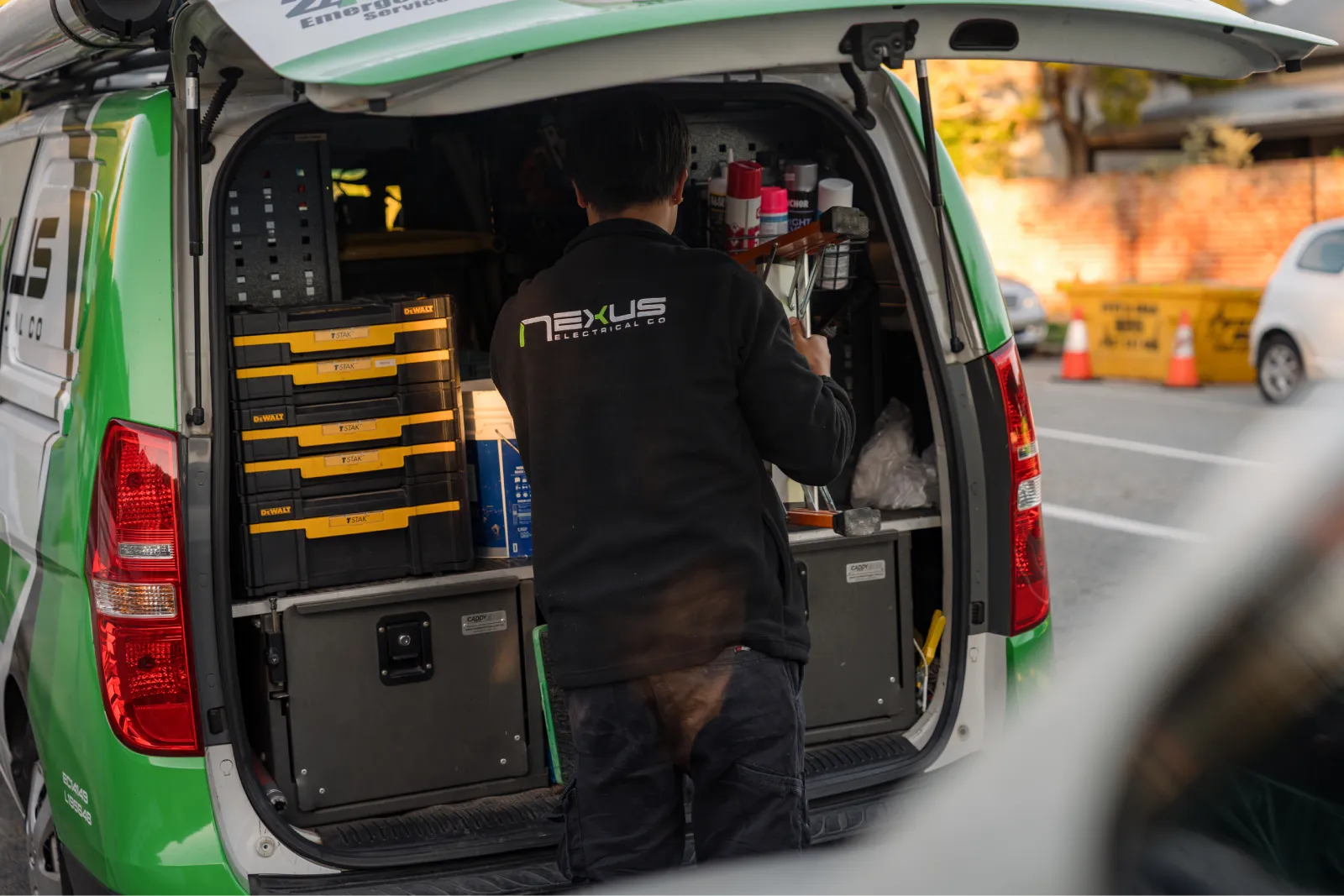 Nexus Electrical Co electrician preparing tools from a service van in Perth