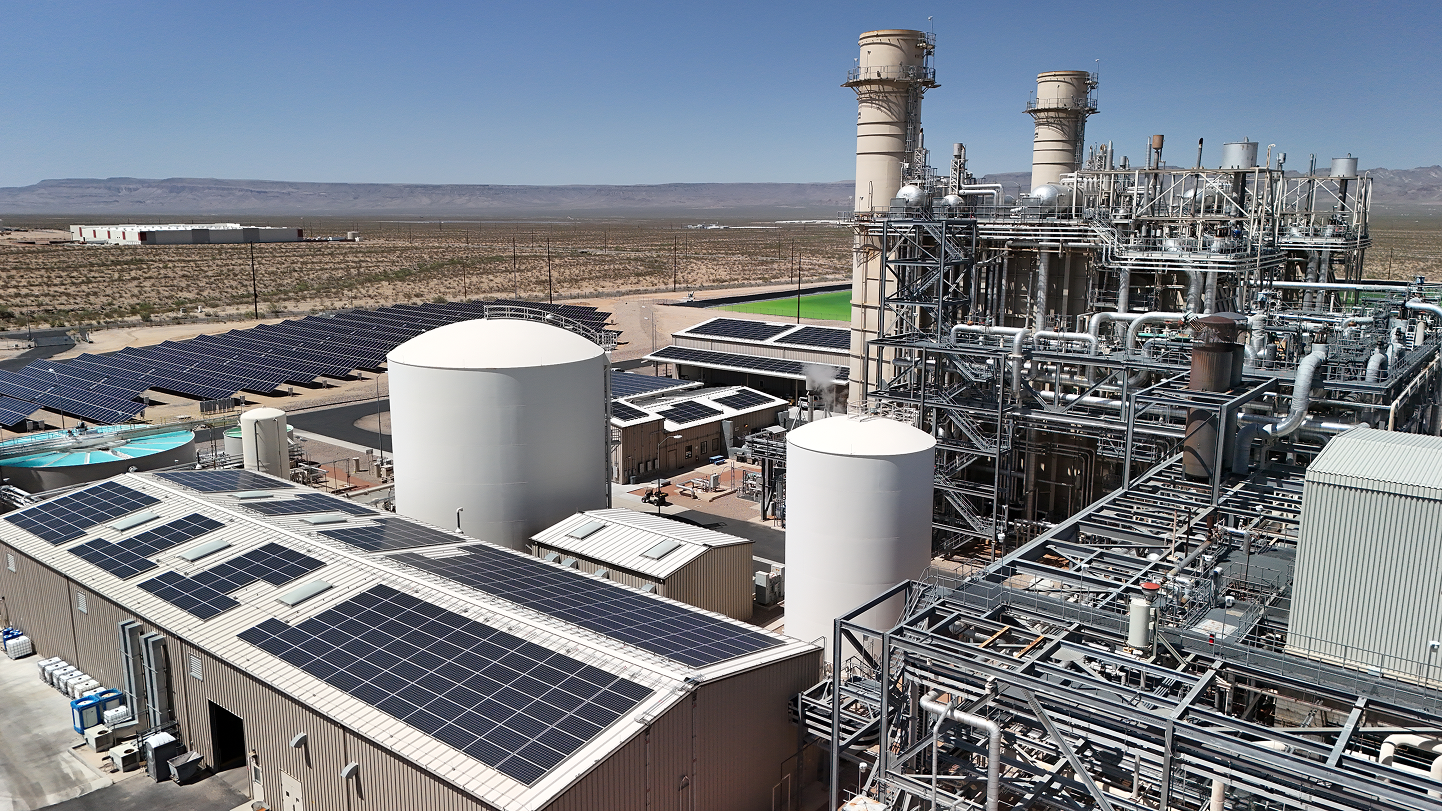 Aerial view of an industrial facility with rooftop solar arrays