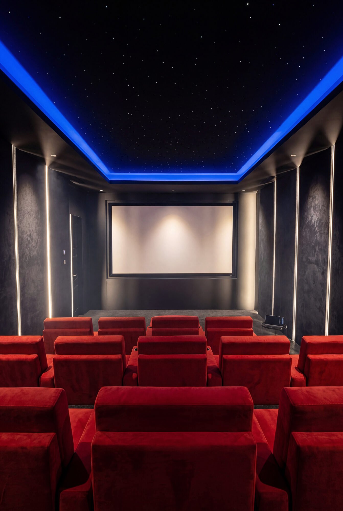 Home cinema with red seats and an illuminated star ceiling