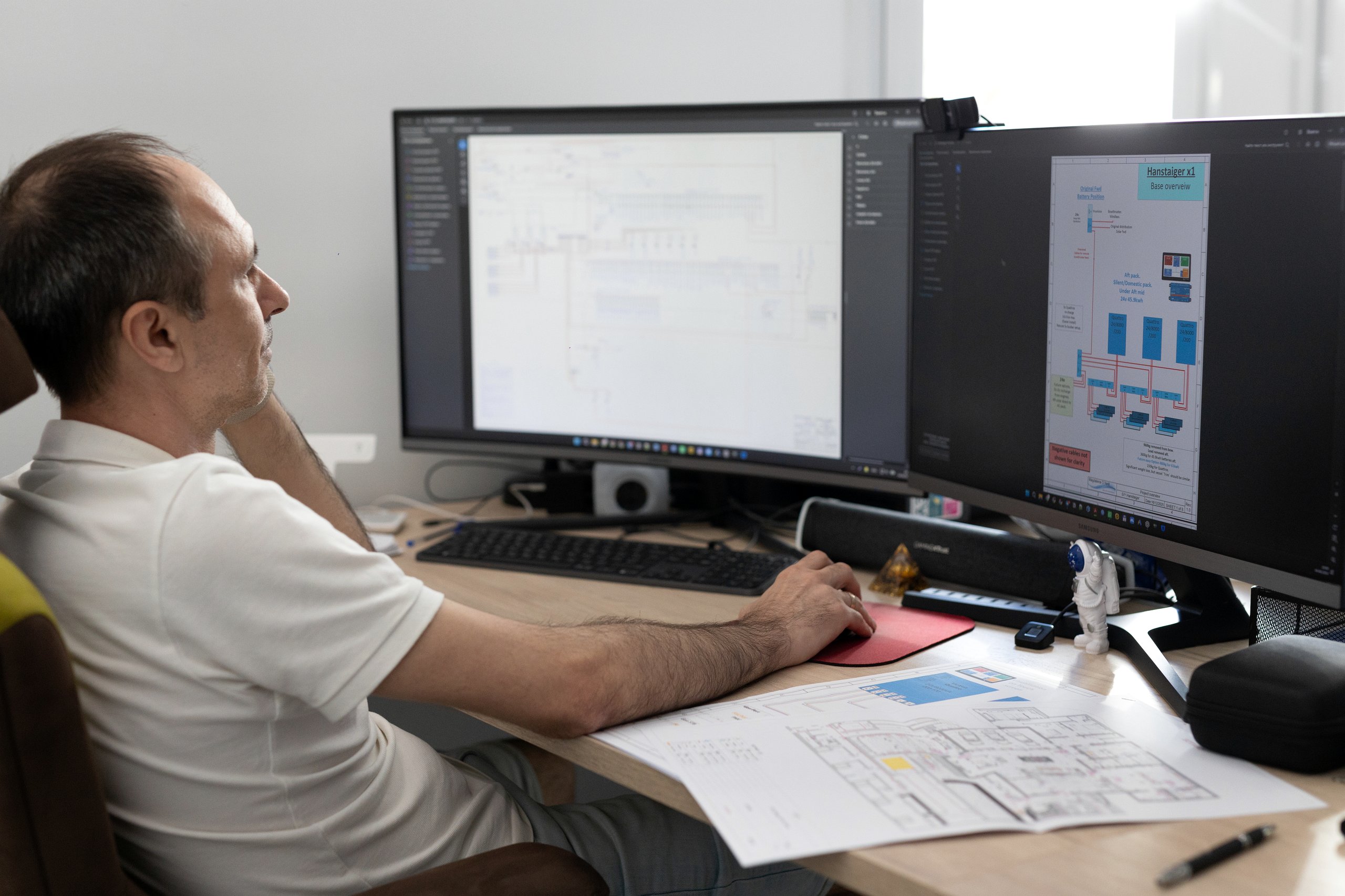 UNCOM engineer reviewing system architecture and project drawings