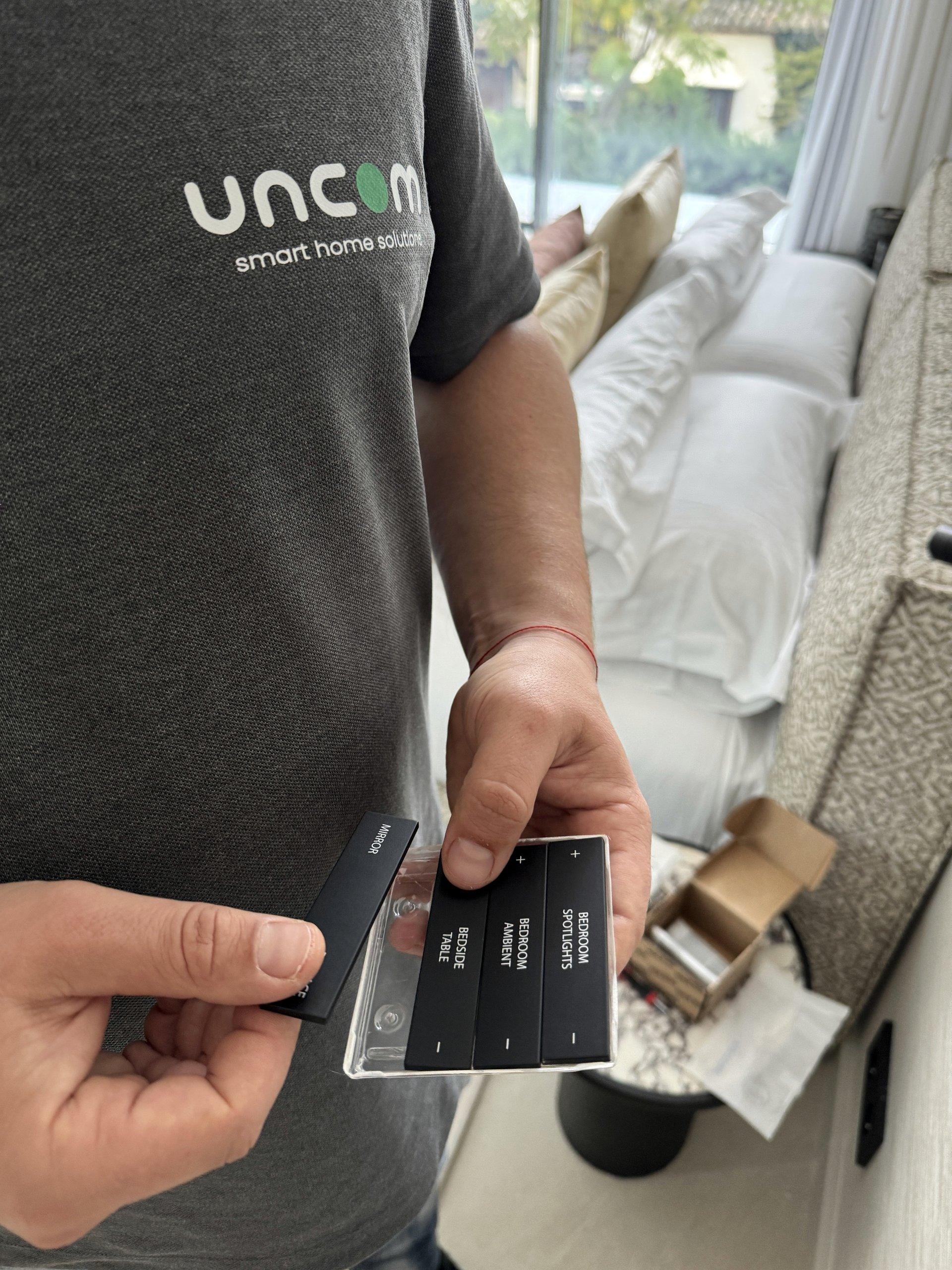 UNCOM technician preparing labelled controls for a bedroom lighting system