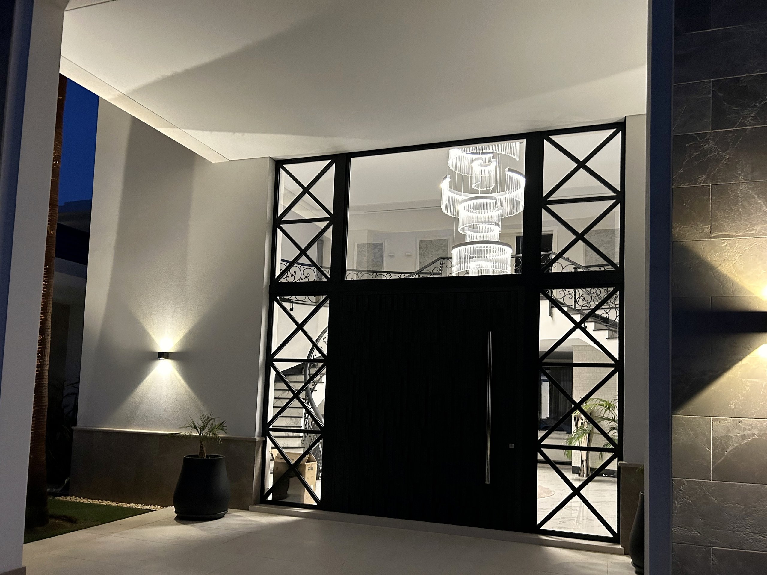 Villa entrance with decorative metalwork and integrated wall lighting